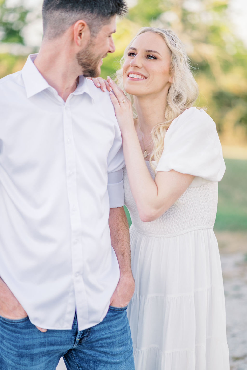 A romantic embrace in front of The Bell of Camden Point at sunset