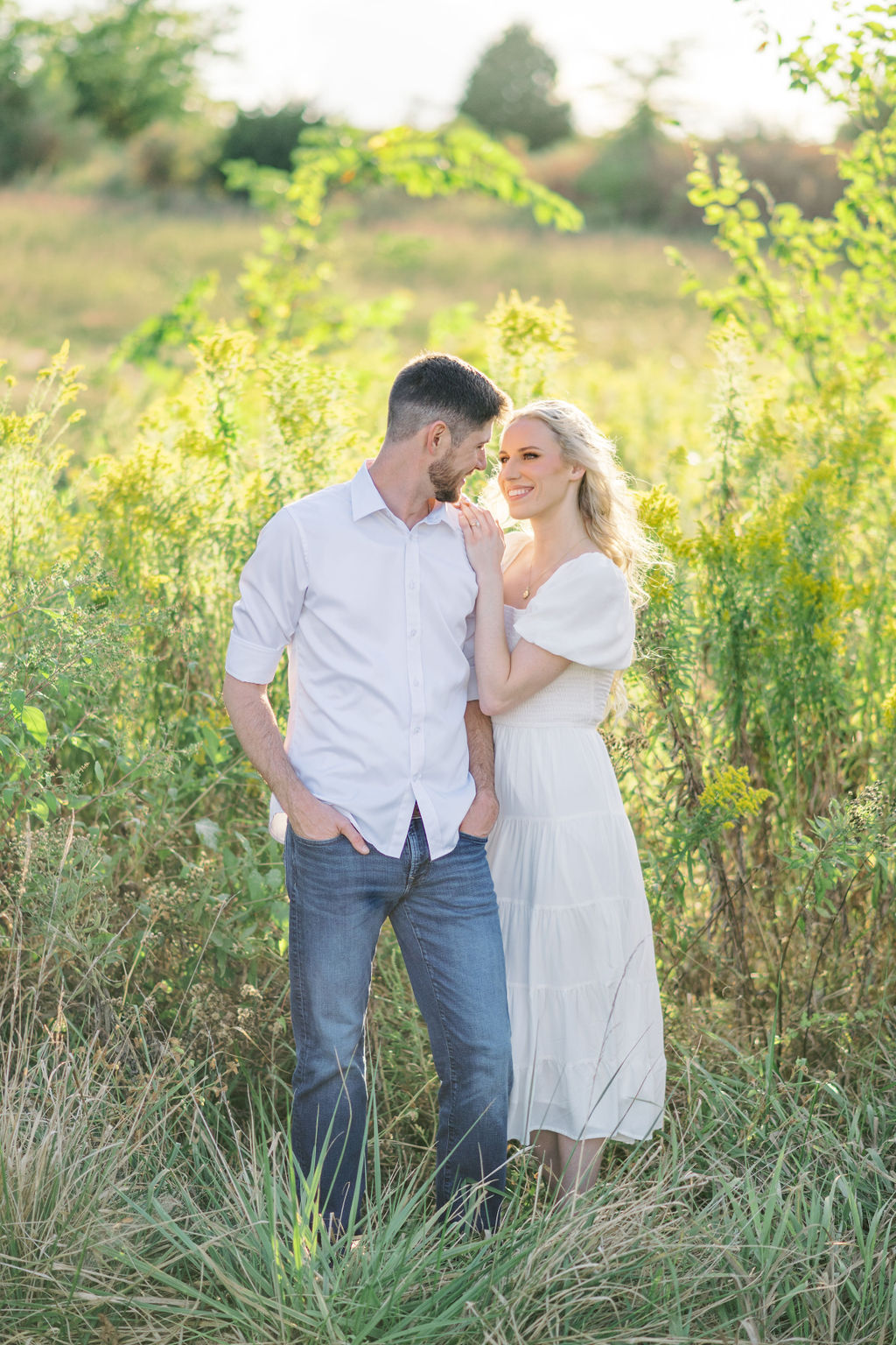 A romantic embrace in front of The Bell of Camden Point at sunset