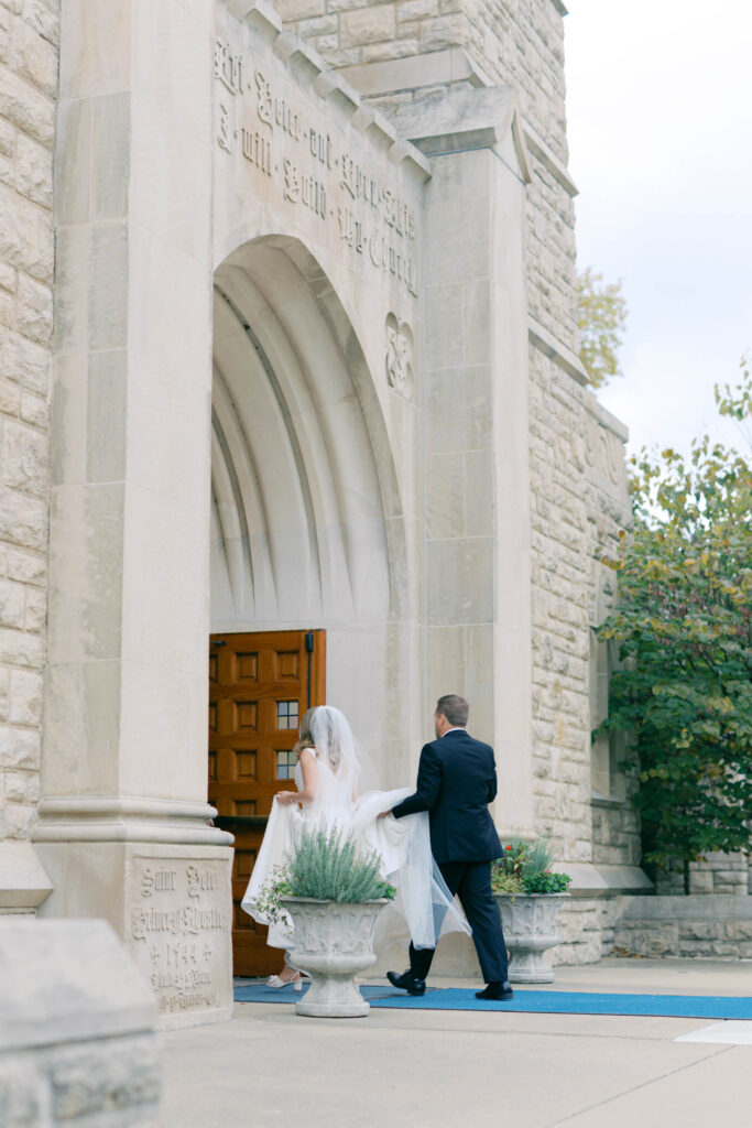 Bride and groom entering a historic Kansas City church for their wedding ceremony