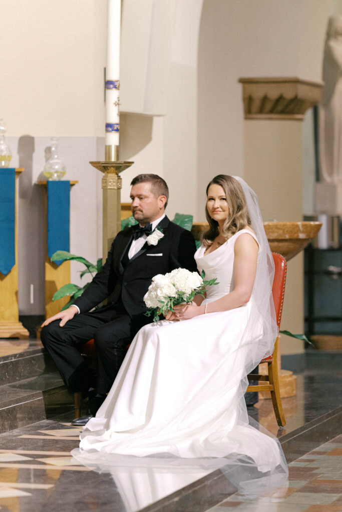 Bride and groom seated together during their traditional church wedding ceremony