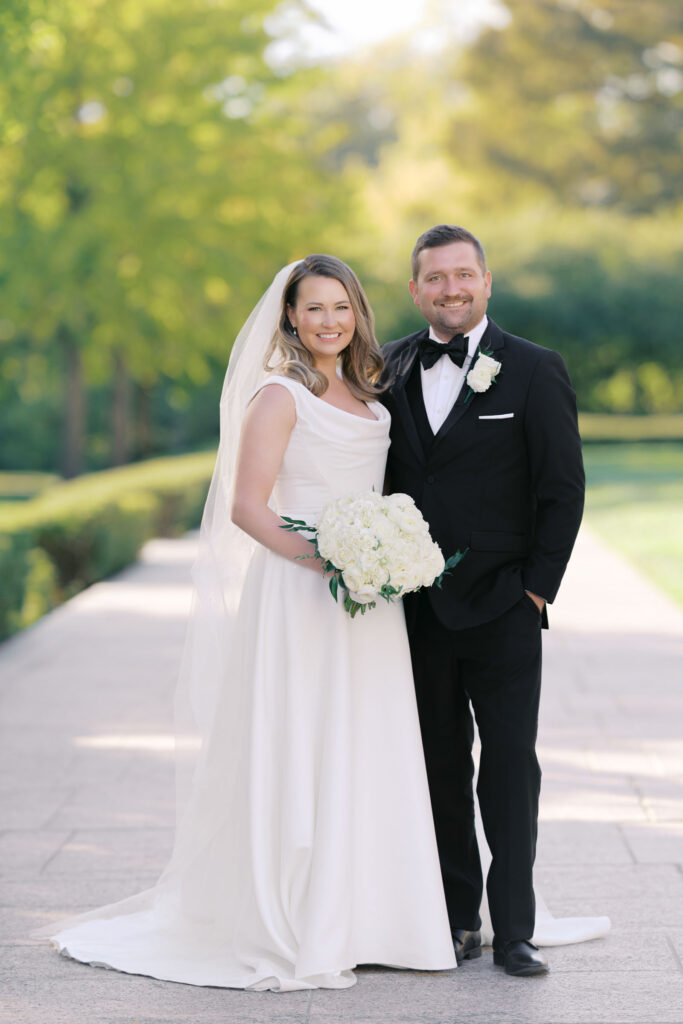 Bride and groom smiling together during outdoor wedding portraits in Kansas City