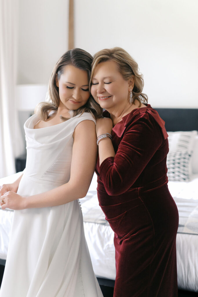 Bride sharing a quiet moment with her mother while getting ready at Crossroads Hotel in Kansas City