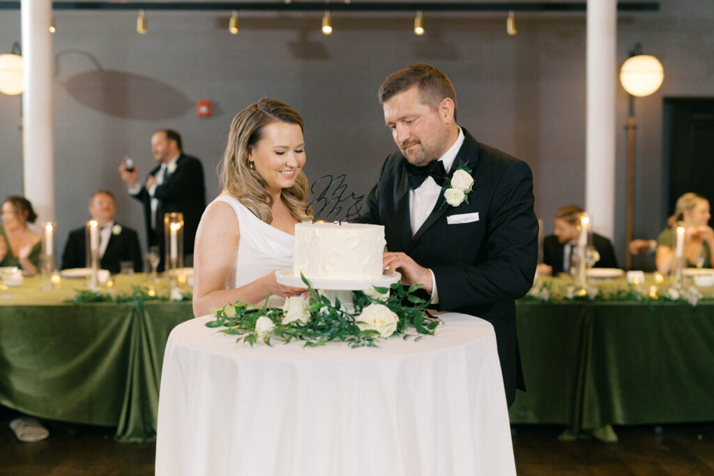 Bride and groom cutting their wedding cake at the reception