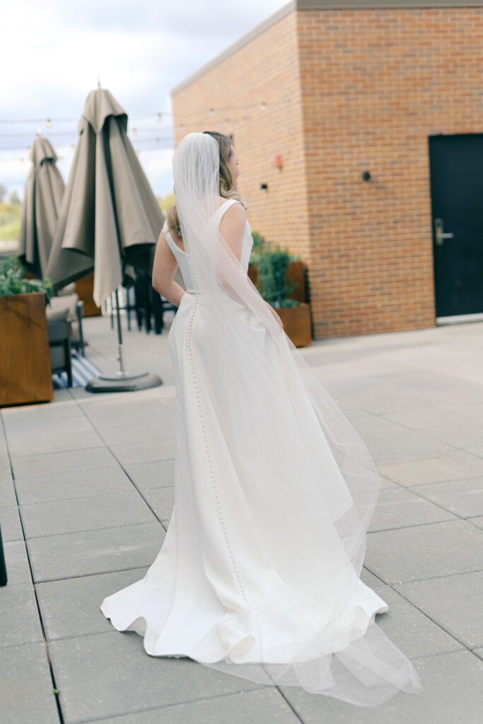 Bride walking on the rooftop terrace at Crossroads Hotel Kansas City in her wedding dress and veil